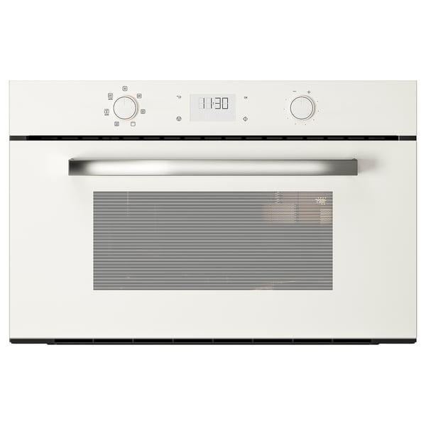 White built-in microwave with digital display and metal handle.