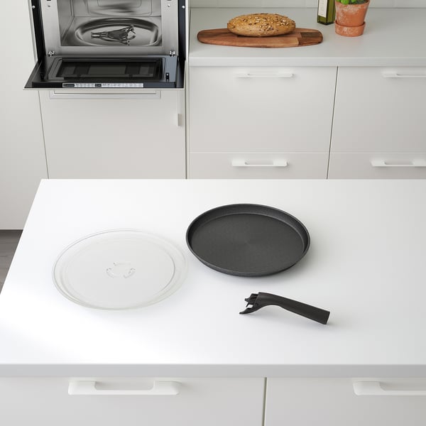 Modern kitchen counter with a microwave oven featuring a rotating plate, crisp plate with handle, and digital display.