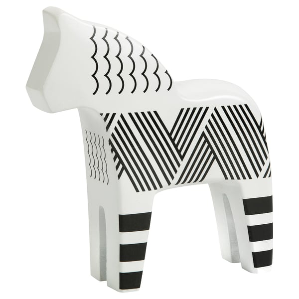 White horse sculpture with black stripes and zigzag patterns, carved from solid pine.