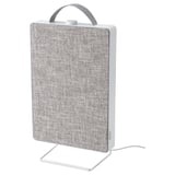 A white FÖRNUFTIG air purifier, rectangular and fabric-covered, on a stand, with a handle on top for portability.