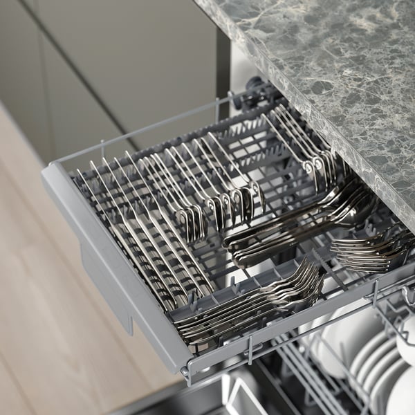 Open dishwasher with cutlery tray and upper baskets, showing organised storage.