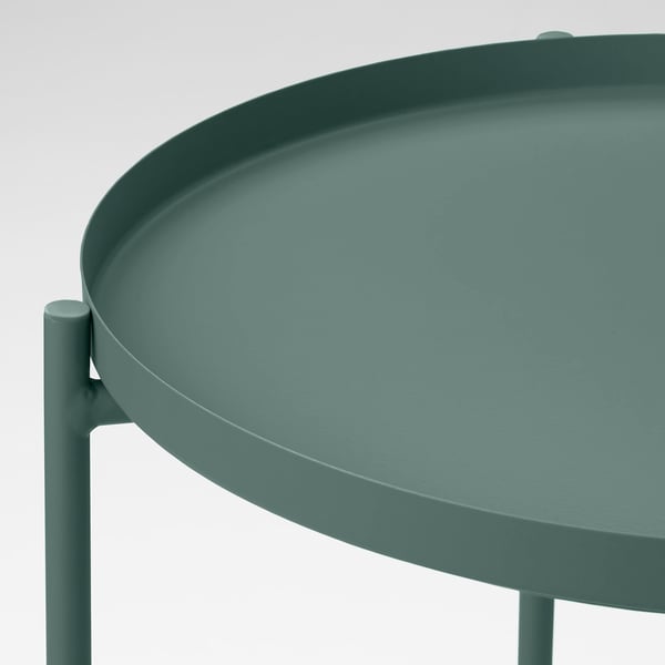 Small, green, round tray table with a smooth, durable surface. Expertly designed with easy-to-carry edges and stable, sturdy legs.