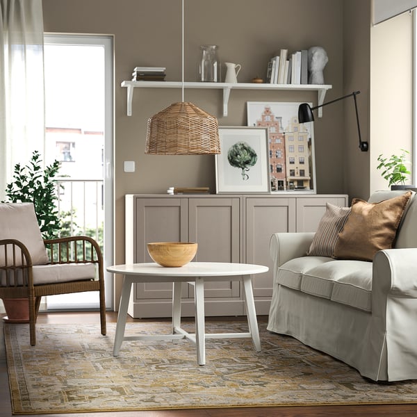 Living room with pastel rug JÄRNVÄG, grey sofa, coffee table, chair, and decor.