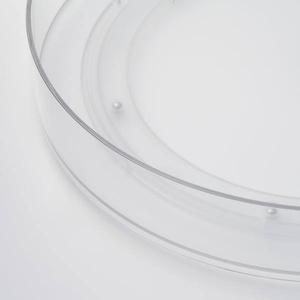 Clear plastic turntable with smooth edge; holds items securely.