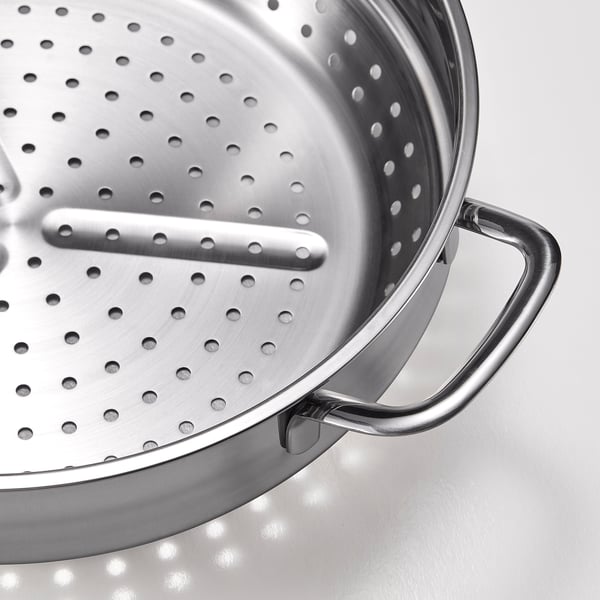 Silver strainer with a long handle and multiple small holes for draining liquid.