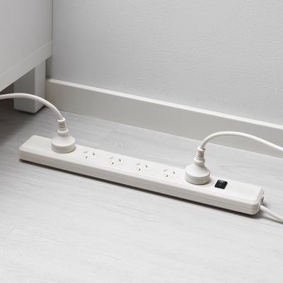 White surge protector with 6 sockets on floor.