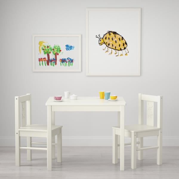 Kids table and chairs set with artwork. Perfect for play, drawing, or arts and crafts for ages 3-6.