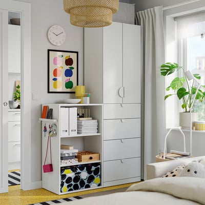Living room with IKEA LASTARE storage unit, books, plants, and modern decor.