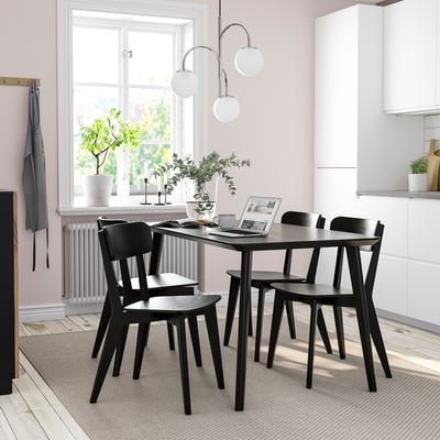 Modern dining set: black LISABO table & chairs, minimalist design, fits neatly under window.