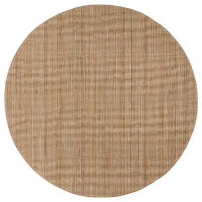 A circular, natural-colored jute rug named LOHALS. Its neutral tones create a calm atmosphere.