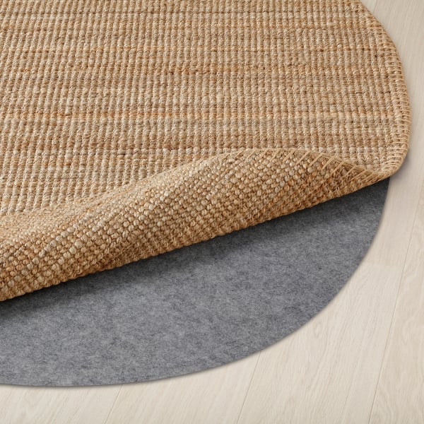 Rug on felt mat. Jute material, durable, easy to clean. Flat-woven, practical for dining area.