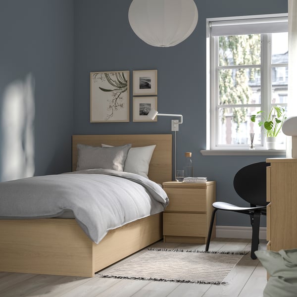 Modern blue bedroom with grey MALM bed, light wood bedside table, and black desk.