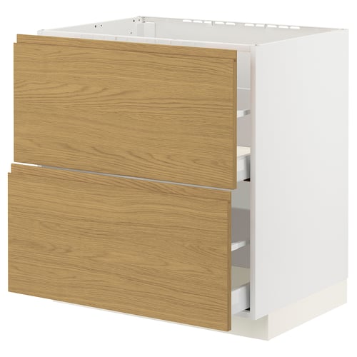 Modern kitchen unit: METOD with light wood fronts, clean lines, and metallic handles.