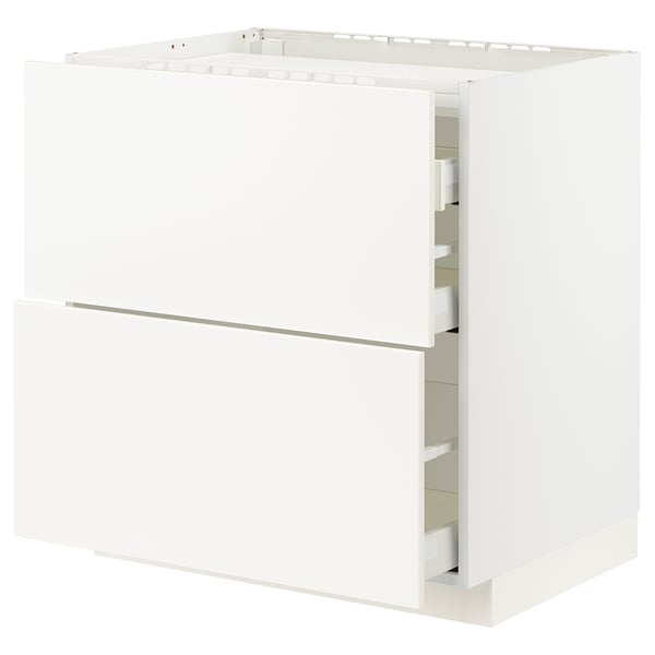 A white METOD kitchen cabinet with smooth, modern design featuring clean lines. It includes drawers and shelves for storage.