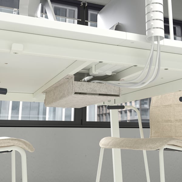 Conference table with footrest, cable management, two stools.