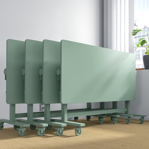 Stackable meeting tables with casters, foldable for storage.