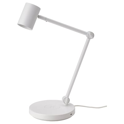 A white, adjustable NYMÅNE lamp with a cylindrical shade, flexible joint, round base, and wireless charging capability.