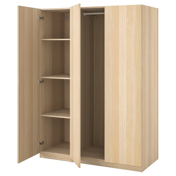 An open light wooden IKEA PAX wardrobe with shelves and hanging space.