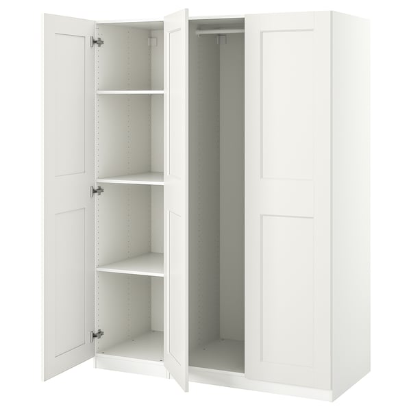 A white ikea PAX wardrobe with open doors, displaying empty shelves.