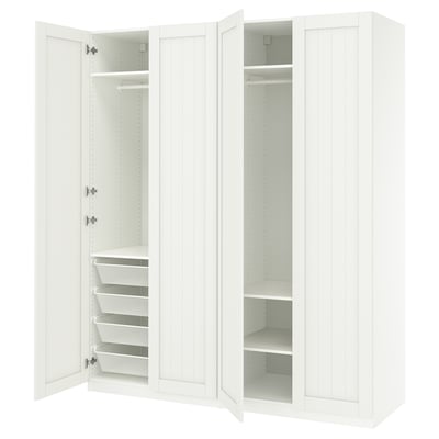 White PAX wardrobe with open doors showing shelves and baskets, simple organised design.