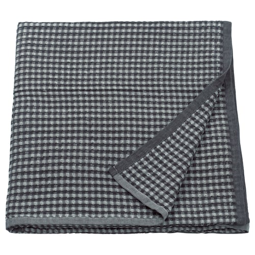 A folded grey gingham PELARTUJA cotton bedspread for double beds; reversible, with a waffle weave texture.