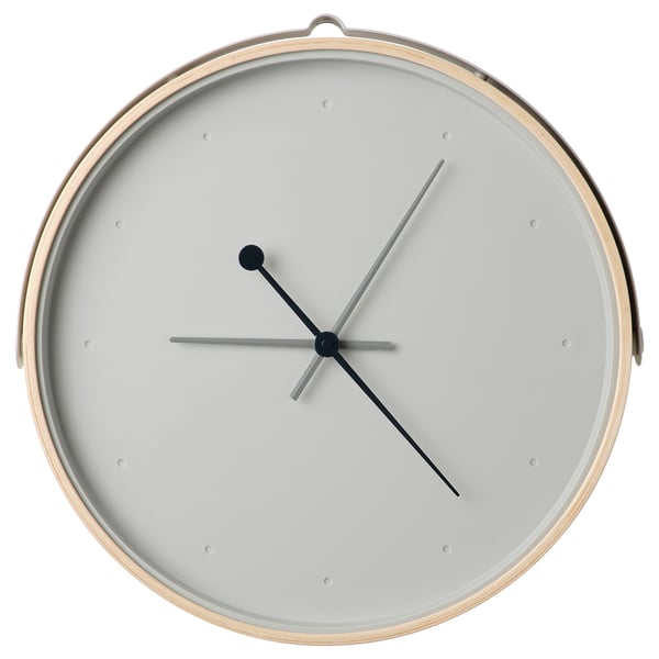 A modern, round, white rotblota clock with a silent quartz movement, featuring grey hands on a glass face surrounded by an ash veneer frame.