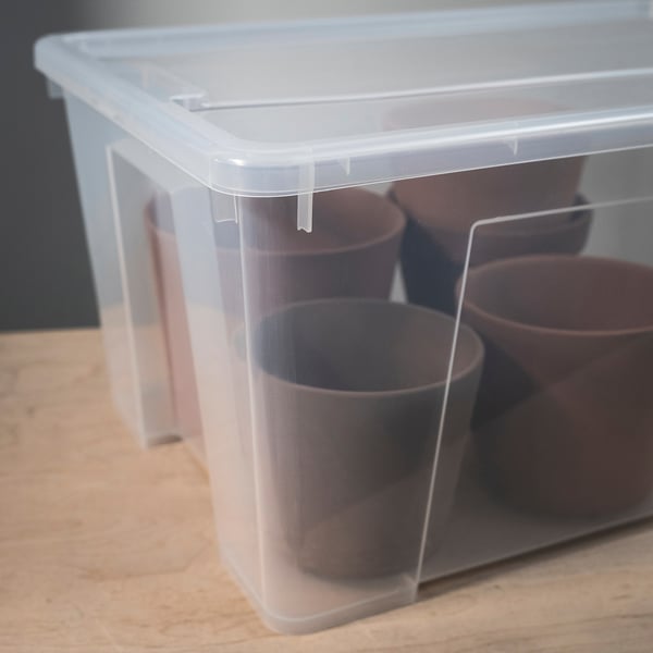 Clear plastic storage box with secure lid, showing contents and keeping items dust-free.