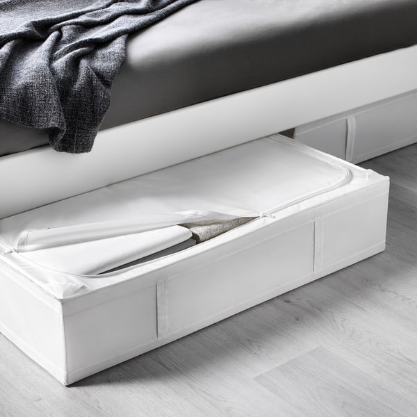 White storage case under bed, open showing folded blankets; ideal for seasonal items.