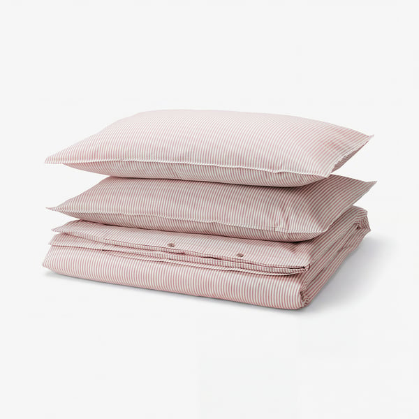Three folded red and white striped cotton duvet covers, neatly stacked, showcasing their soft, rectangular shape with yarn-dyed stripes.
