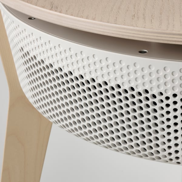 Close-up of a modern table with a textured white surface, featuring a sleek, perforated air purifier section.