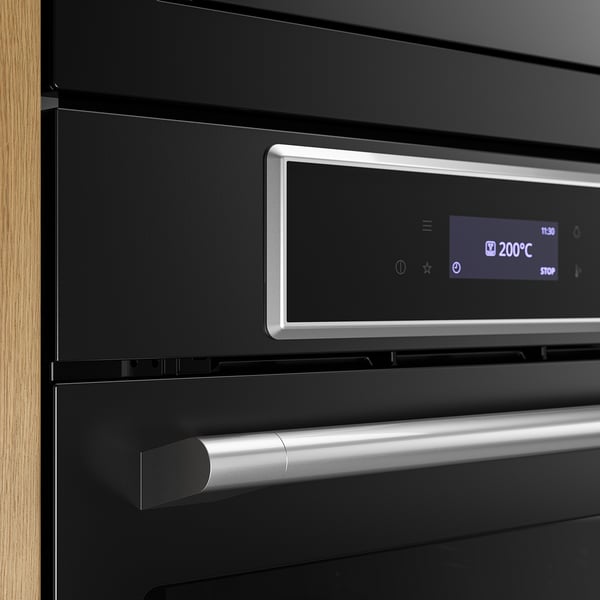 Modern black oven with digital display and silver handle, showcasing quality and sleek design.