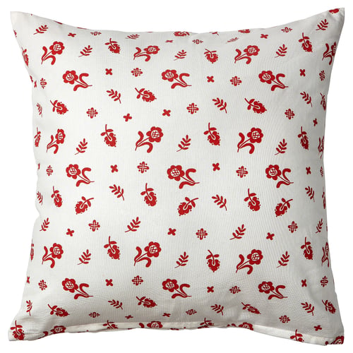 A white square throw pillow with red floral patterns, featuring traditional swedish designs. The fabric is cotton.