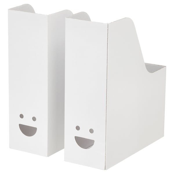 Two white TJABBA magazine files, upright with smiling faces cut out.