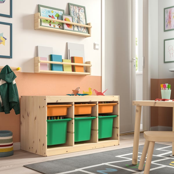 Kids room with TROFAST light wood storage. Green storage bins, books, art, and origami. Bright, organised, child-friendly space.