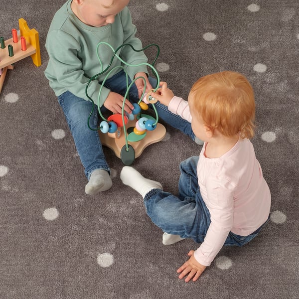 Kids playing with UPPSTÅ beads, practising fine motor skills.