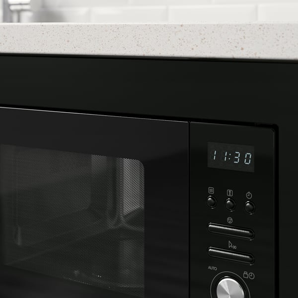 Black microwave at 11:30 on speckled counter, controls visible.