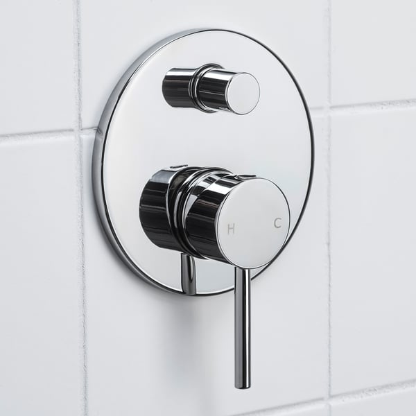 Polished chrome shower mixer. Round handle controls water flow. Labelled h and c.