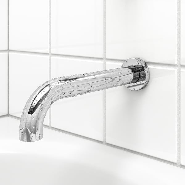 Chrome bathroom tap with shower diverter on tiled wall.