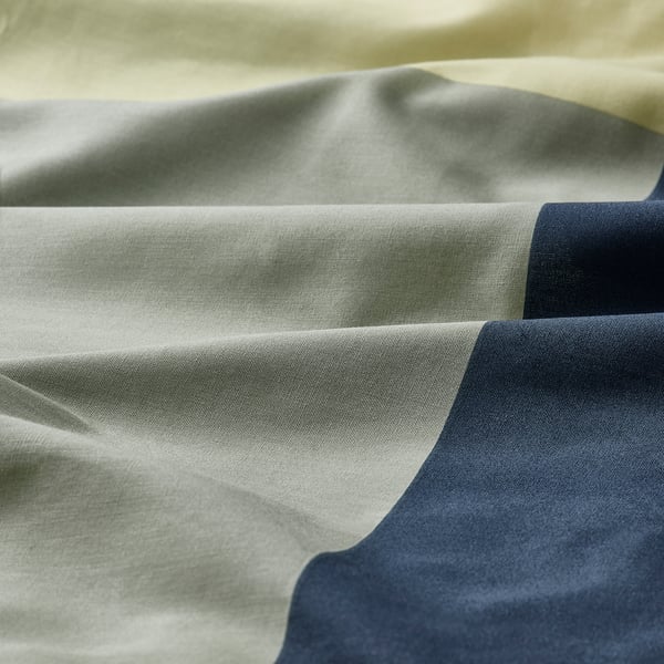 Soft fabric close-up, showing smooth texture and intricate weave, likely a high-quality cotton blend.