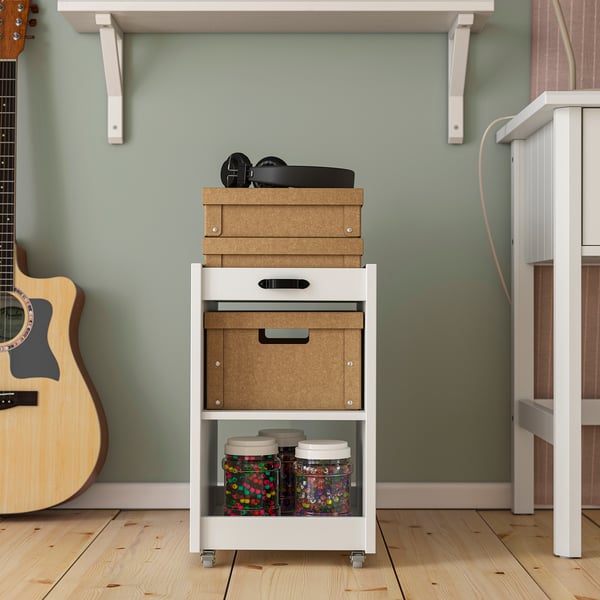 A mobile storage unit with boxes and jars on wheels, for easy organisation and access.