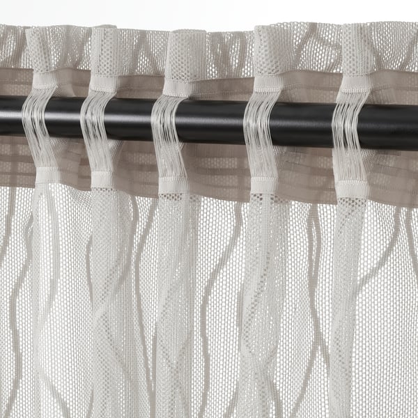 Sheer wave-patterned grey curtains on black rod, offering privacy and light.