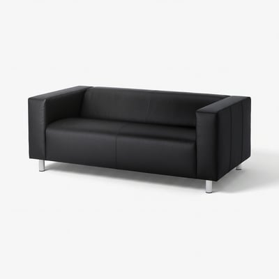 Black leather sofa, modern design, angular shape, clean lines, raised on metal legs.