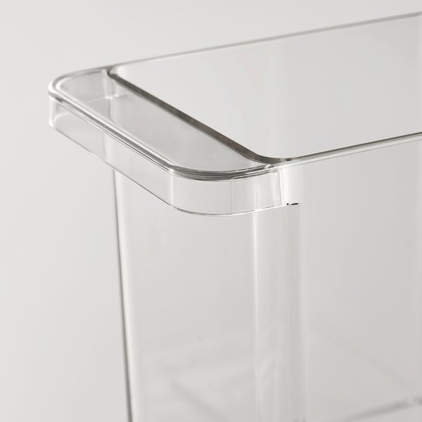 Clear plastic storage box with rounded handle, designed for fridge organisation. Transparent, stackable, with a smooth, sturdy build.