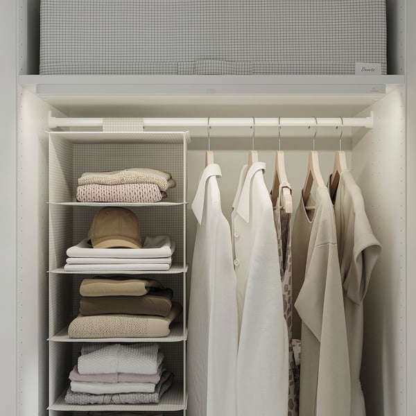 Closet with colorado shelves, organised clothes, and hanging garments.