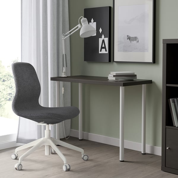 Dark grey LINNMON desk next to window, with chair and books.