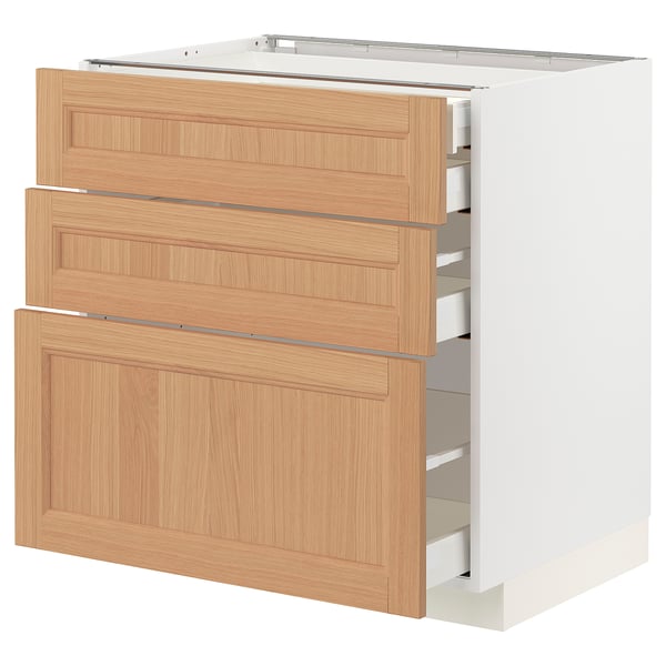 METOD kitchen cabinet with oak drawers, three partially open.