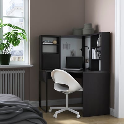 MICKE: modern corner workstation with laptop, adjustable shelves, and chair in cosy bedroom.