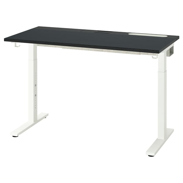 An adjustable MITTZON desk with a black top and white legs. It has a sleek, modern design with cable management slots.