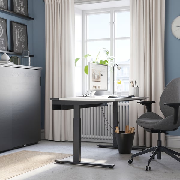 Modern home office: MITTZON desk, grönfljäll chair, large window, storage cabinet.