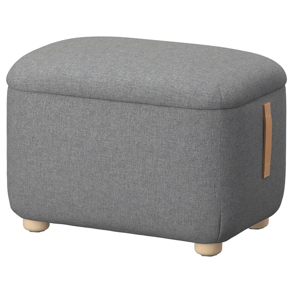 The OSKARSHAMN grey fabric footstool. It a round shape with wooden legs and a leather handle, designed for comfortable resting and storage.